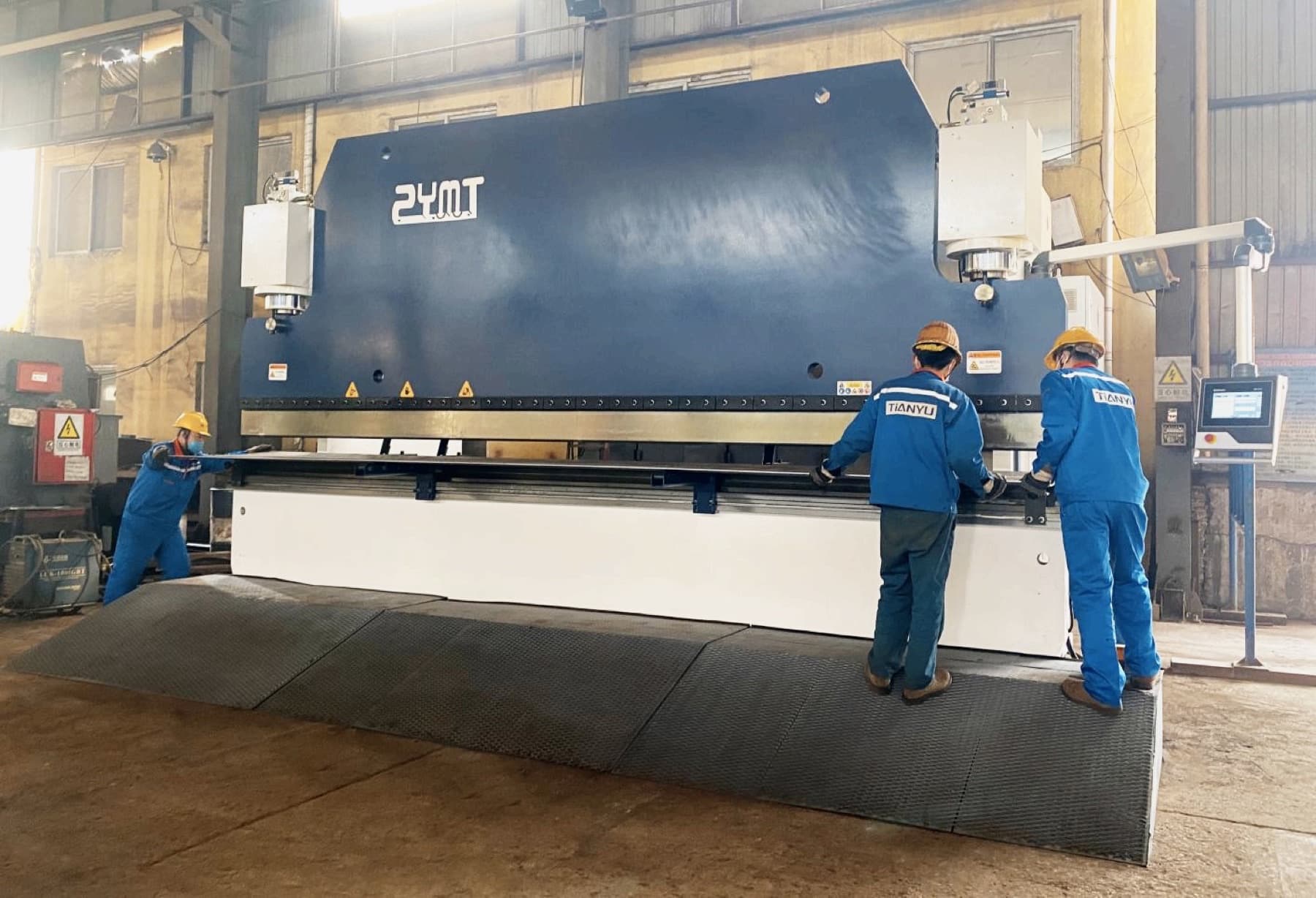 TIANYU operators running a CNC press brake in-house