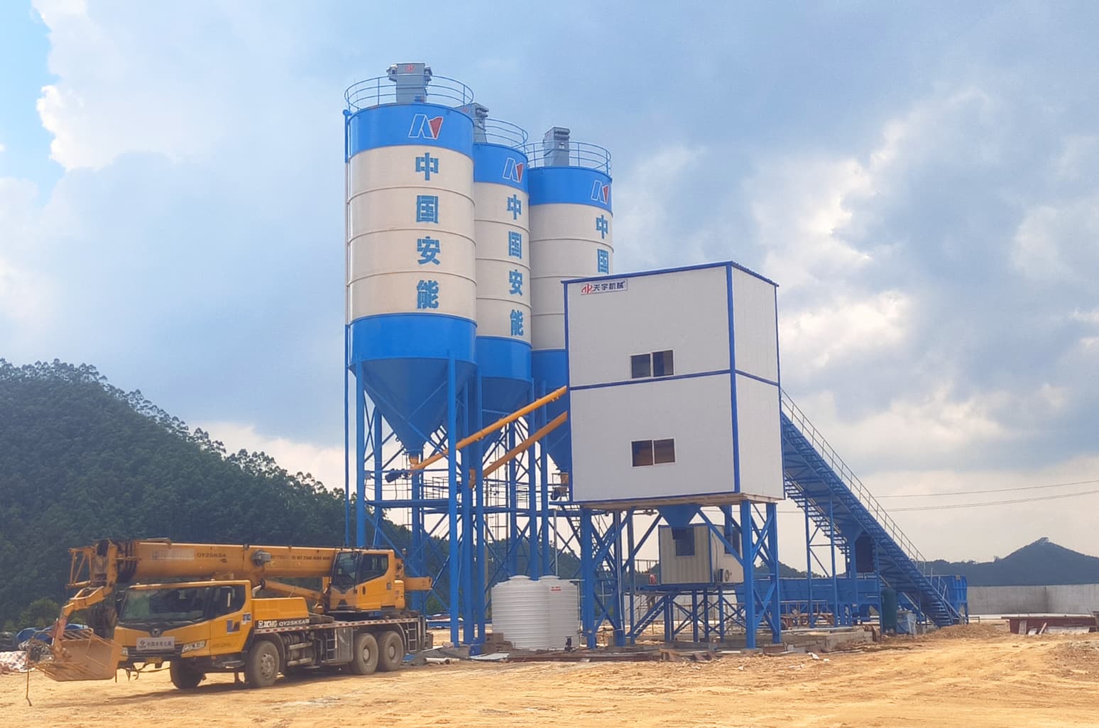 TIANYU HZS**Q engineering concrete batching plant with three cement silos, mixing house, and belt conveyor on a large infrastructure site